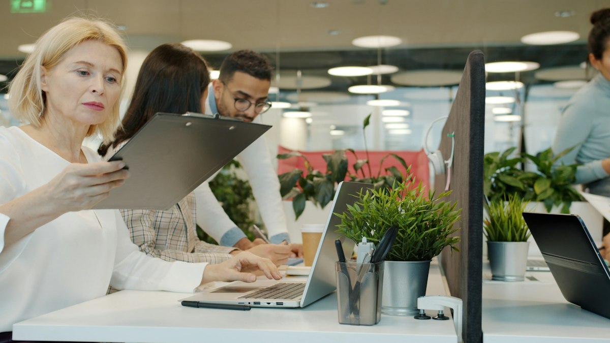 Two colleagues reviewing a document together at their desk